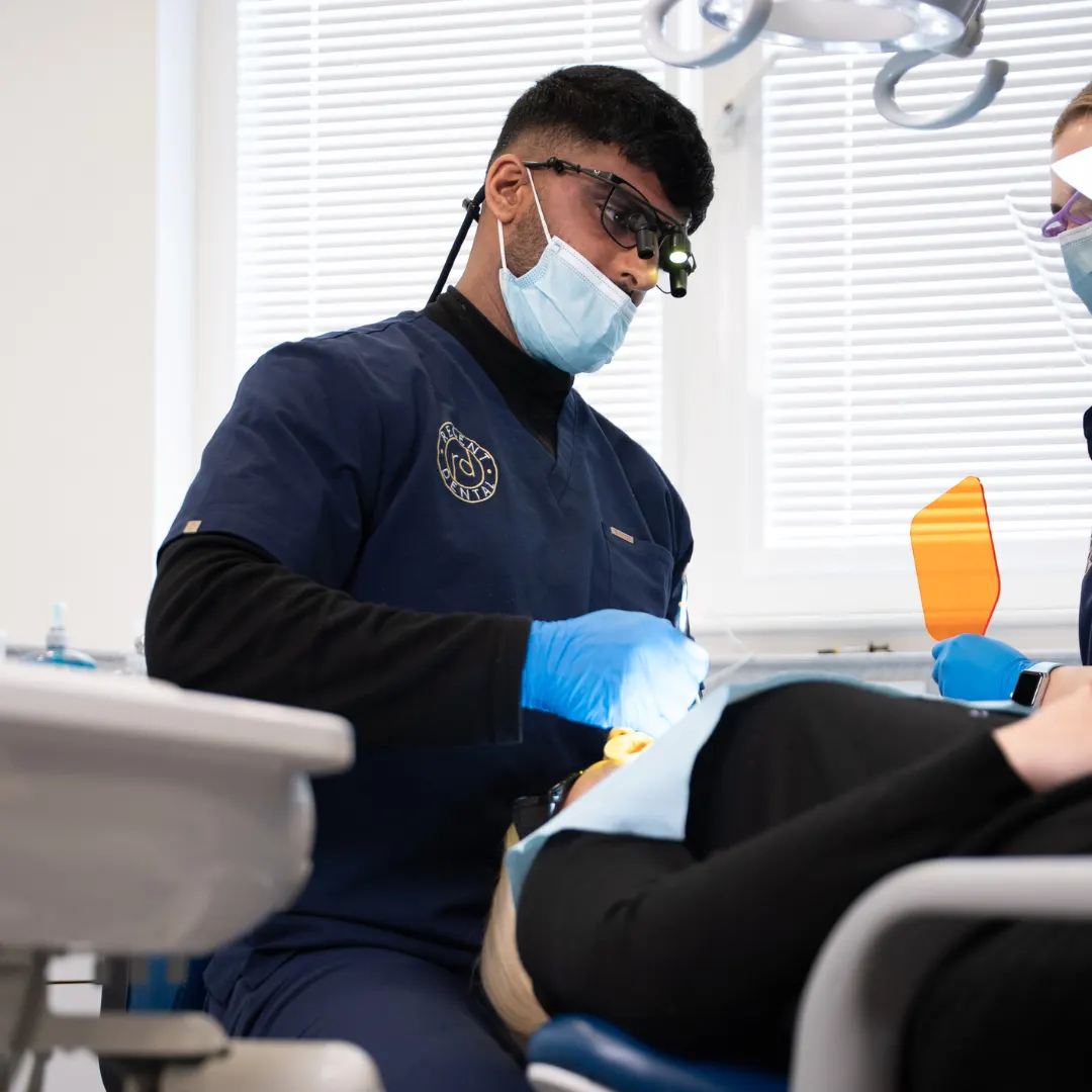 Dentist refining the edge of a front tooth during tooth reshaping treatment at Regent Dental in Ilkley
